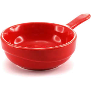 A bright red serving dish with a handle, featuring a smooth, glossy finish.