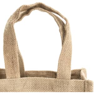 A natural jute bag featuring two sturdy handles and a textured surface. It includes a logo on the side.