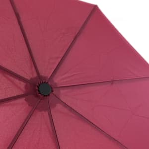 A red umbrella featuring a central hub and multiple panels. It has a logo on the handle.
