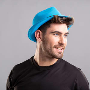 A blue brim and bucket hat worn by a man with short hair, smiling against a neutral background.