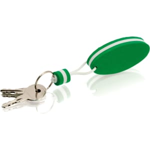 A green Soke keyring features a soft oval design with white stripes, attached to a keyring with keys.