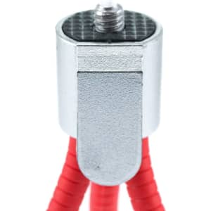 A red tripod with a silver top piece and textured surface, featuring a mount for devices.