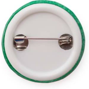 A lapel pin featuring a green outer edge and a secure metal clasp on the back. It has a plain white surface.