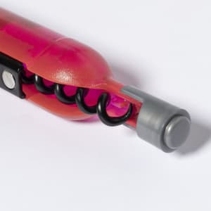 A pink and grey corkscrew with a spiral design, featuring a black corkscrew mechanism and a grey end cap.