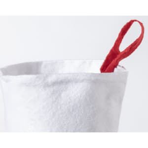 A white fabric container with a red loop attached to the top.