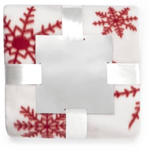 A soft blanket featuring red snowflake patterns on a white background, tied with a silver ribbon.