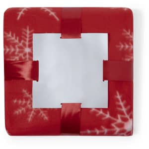 A red blanket with a snowflake design and satin ribbon accents. It features a central cut-out section.