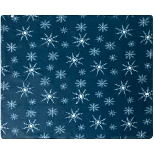 A navy blue blanket featuring a snowflake pattern in white. The blanket has a soft texture and is branded.