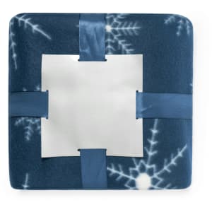 A blue blanket with a winter snowflake pattern, featuring satin ribbon ties in a cross design and a central panel.