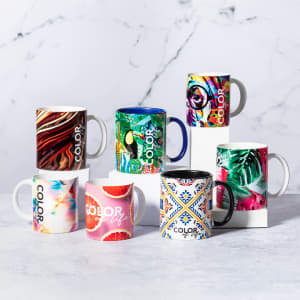A collection of colourful mugs featuring various vibrant patterns, including floral, abstract, and geometric designs.