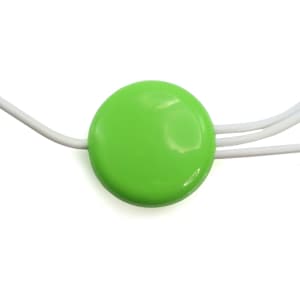 A round green USB hub with three white cables extending from it. It features a smooth, glossy surface.