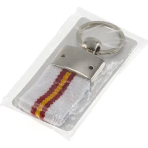 A keyring with a silver metal attachment and a white, red, and yellow striped fabric fob, packaged in a clear bag.
