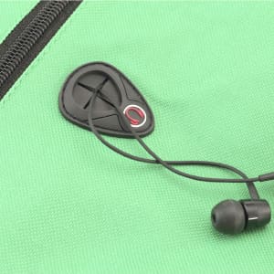 A green backpack with a zippered pocket and earphone jack, featuring a pair of black earbuds.