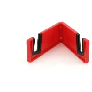 A red and black phone stand with a triangular shape designed to hold devices securely.