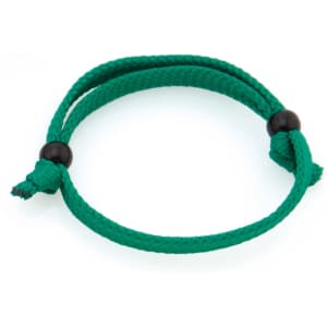 A green Mitjansi bracelet made of braided rope, featuring two black beads for adjustment.