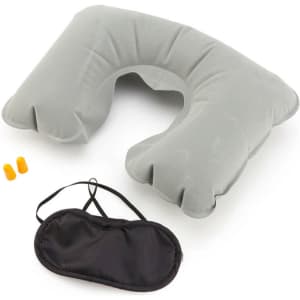 A grey travel neck pillow, earplugs, and a black eye mask in a compact arrangement. The pillow features a cut-out design.