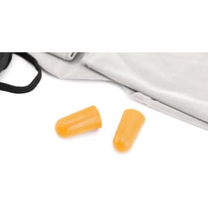 Two orange earplugs placed on a light grey surface, accompanied by a black carrying bag.