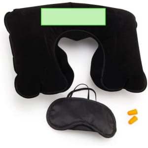 A black travel pillow, an eye mask, and earplugs in a compact set with a carrying strap.
