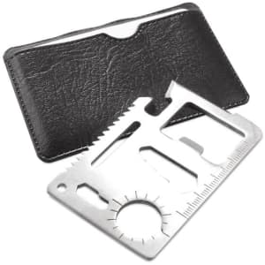 A silver multitool with various functions, placed on a black leather wallet. The multitool features a ruler and saw.
