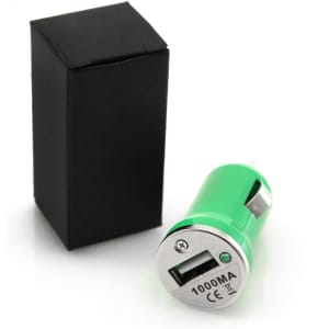 A green USB car charger beside a black box, featuring a silver connector and branding.