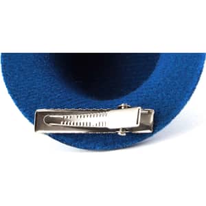 A blue hair clip with a silver clasp, featuring a soft fabric texture. The clip has a branding logo.