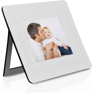 A white photo frame with a black border, displaying a picture of a man holding a baby.