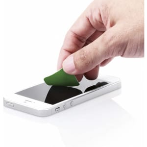 A person's hand using a green cleaning cloth on a smartphone screen. The phone has a white casing.