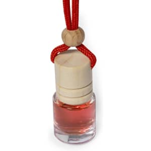 A glass air freshener bottle with a wooden cap, hanging from a red cord. The liquid inside is a pinkish colour.