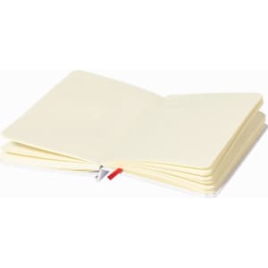 An open notepad with cream-coloured pages and a white cover, featuring a red ribbon bookmark.