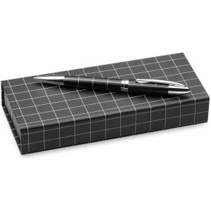 A black Dacox pen rests on a grid-patterned black box. The pen features a metallic finish and a sleek design.