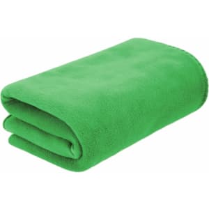 A folded green blanket made of soft fabric, featuring a smooth texture. The blanket has a logo on it.