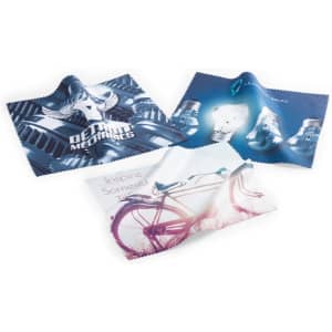 Three Gildor cleaning cloths in various designs, featuring blue and white graphics, with a logo on one cloth.