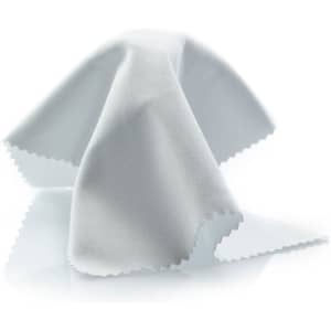 A white cleaning cloth with scalloped edges, presented on a reflective surface. It has a logo.