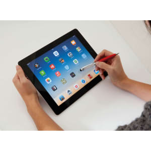 A hand holding a red stylus touch ball pen, interacting with a tablet displaying various app icons.