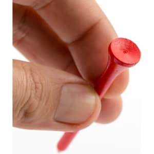 A red golf tee held between fingers, featuring a round head and a slender shaft. It has a visible logo.