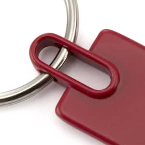 A red keyring with a metal loop, featuring a rectangular design and a smooth finish.