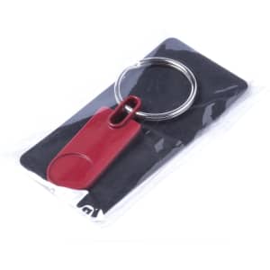A red keyring with a smooth oval attachment, presented on a black backing and sealed in clear packaging.