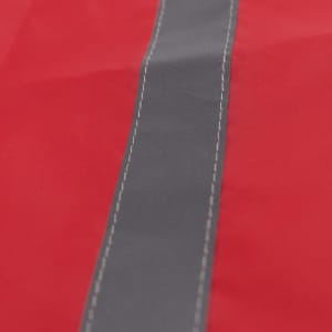 A red drawstring bag features a central grey stripe and contrasting stitching, with a logo present.