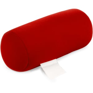 A red cylindrical pillow with a soft fabric surface and a small tag attached.