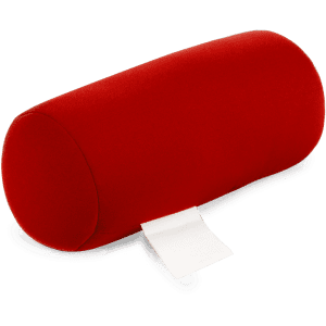 A red, cylindrical pillow with a soft fabric cover and a small white tag attached. It has a smooth surface.