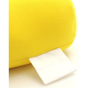 A bright yellow pillow with a white label tag attached.