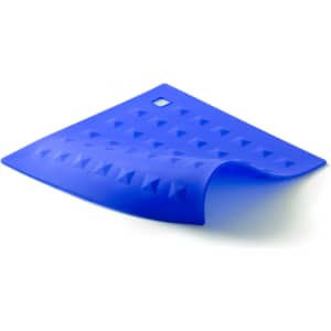 A blue silicone placemat with a textured surface featuring raised triangles and a small hole for hanging.