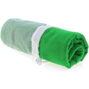 A rolled green gym towel enclosed in a mesh bag, featuring a drawstring closure.