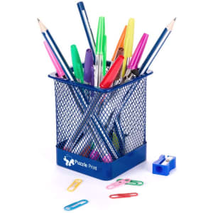 A blue mesh pencil holder filled with various pens, markers, pencils, paperclips, and a sharpener.