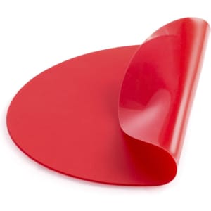 A bright red mousepad with a glossy finish, featuring a slight curl at one edge and a logo.