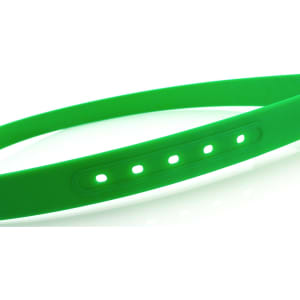 A green silicone belt featuring multiple adjustment holes and a sleek design, showcasing a minimalist style.