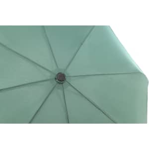 A green umbrella with a central hub and radial spokes, showcasing its fabric texture and structure.