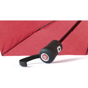 A red umbrella with a black handle and strap, featuring a logo on the handle.