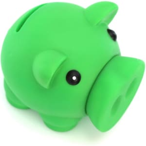A green pig-shaped money box with a glossy finish and black eyes, featuring a coin slot on the top.