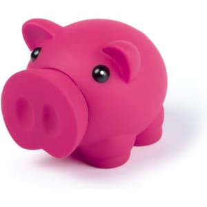 A pink pig-shaped money box with black eyes, made of soft material. It has a rounded design and a slot for coins.